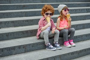 photo of two cute hipsters eating icecream
